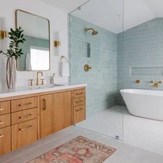 a bathroom with two sinks and a bathtub next to a mirror on the wall