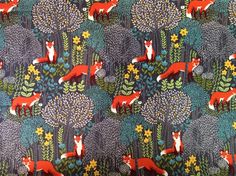 an image of foxes in the woods on blue background with flowers and leaves, printed fabric