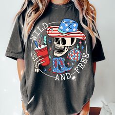 Comfort Colors® Retro wild and free Graphic Tee, Comfort Colors 4th of July Graphic Tee, skeleton Graphic Tee, USA Comfort Colors Hi, welcome to CCAPPARELTX! If you are looking for trendy lifestyle apparel for your best moments in life, then you have come to the right place. You can find comfortable and casual clothing that you can CUSTOMIZE, for you and your loved ones. We hope you enjoy your time at our shop, the processing time is currently 1-5 days. If you would like to rush your order, plea Summer Skull Print Crew Neck Top, Skull Print Crew Neck Top For Summer, Black T-shirt With American Flag Print For Summer, Black Graphic Tee With American Flag Print, 4th Of July Streetwear Tops With Graphic Print, Casual Summer Skull T-shirt, Casual Black Tops For 4th Of July, Summer American Flag Print Tops For Streetwear, American Flag Print Tops For Summer Streetwear