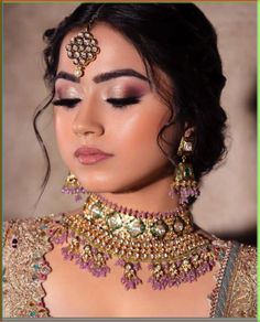 a woman wearing an elaborate necklace and earrings