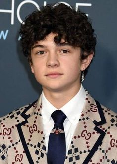 a young man wearing a suit and tie