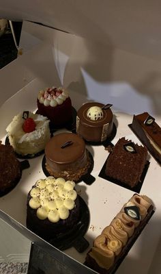 a table topped with lots of different types of cakes and desserts next to each other