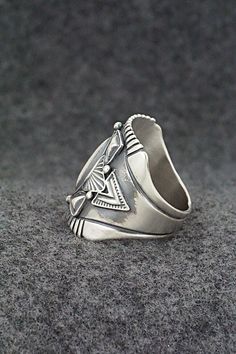 This finely crafted sterling silver ring was made by Navajo silversmith Derrick Gordon. The back is signed Derrick and stamped sterling.Size: 10Length: 1"Free shipping on all orders! We ship with USPS and always include tracking. All orders ship within a day of payment.Returns are accepted up to 30 days after you receive your order. Just send us a message. Our shop offers cash back or store credit. The item must be returned in new condition. Artisan Stamped Rings As Collectibles, Southwestern Silver Open Ring Jewelry, Southwestern Style Silver Open Ring Jewelry, Unique Stamped Antique Silver Rings, Vintage Silver Turquoise Ring With Polished Finish, Silver Engraved Southwestern Turquoise Ring, Engraved Silver Turquoise Ring In Southwestern Style, Unique Silver Turquoise Concho Ring, Engraved Silver Turquoise Southwestern Ring