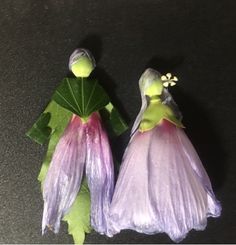 two plastic figurines made to look like brides with veils and flowers