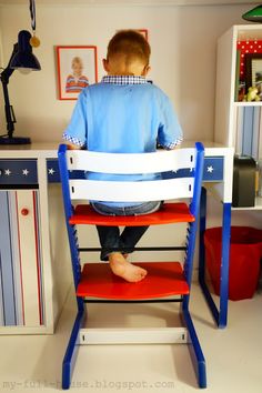 a young boy sitting in a chair at a desk