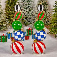 two christmas ornaments sitting on top of each other