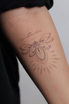 a woman's arm with a tattoo design on the left side of her arm