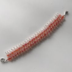 Nice White & Orange Bracelet, Hand Made. Handmade Orange Beaded Bracelets For Party, Adjustable Coral Jewelry For Parties, White Friendship Bracelets With Round Beads For Party, White Handmade Friendship Bracelets For Parties, Handmade White Friendship Bracelets For Party, Elegant Handmade Coral Beaded Bracelets, Elegant Handmade Orange Bracelets, Elegant Handmade Friendship Bracelets For Party, Elegant Handmade Coral Bracelet