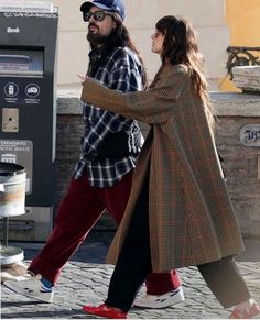 a man and woman walking down the street