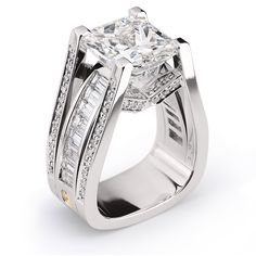 an engagement ring with a princess cut diamond surrounded by baguets and channeled diamonds