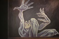 a painting with two hands reaching out to touch another person's hand, in front of a black background