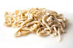 a pile of noodles sitting on top of a white plate