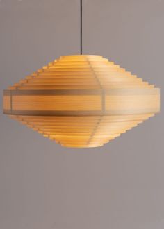 a light fixture hanging from a ceiling in a room with grey walls and flooring