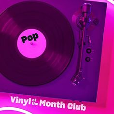 a vinyl record player in front of a purple background with the word pop on it