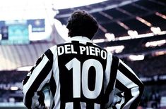 the back of a soccer player's jersey at a game in an empty stadium