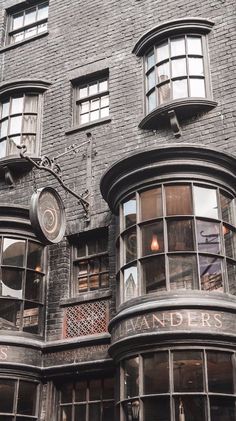 an old building with many windows and a clock on the side