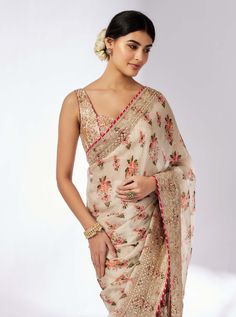 Embrace elegance with this delicate floral jaal sari, featuring layered frills, flounce, and an intricately embroidered border. The easy wrap design is complemented by a classic sleeveless printed blouse that adds a touch of glamour and glitz, making this ensemble perfect for any special occasion. Transitional Floral Embroidered Pre-draped Saree, Pre-draped Saree With Embroidered Border For Reception, Transitional Pre-draped Saree With Embroidered Border For Reception, Transitional Bollywood Style Pre-draped Saree With Floral Embroidery, Transitional Season Pre-draped Floral Saree, Transitional Pre-draped Floral Saree, Eid Floral Print Pre-draped Saree, Elegant Pre-draped Saree With Floral Embroidery In Tissue Silk, Anarkali Style Pre-draped Saree With Floral Print For Wedding