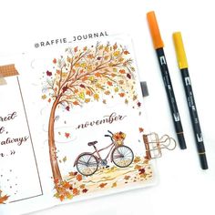 a notepad with an autumn tree and bicycle on it