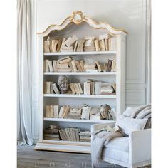 a white bookcase filled with lots of books