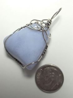 Blue Lace Agate Pendant Wire Wrapped in .925 Sterling Silver Round Wire This uplifting, refreshing stone offers a soft consistent pale sky blue appearance and a calm, peaceful presence. Best with pastels of a different color; many dark or bright contrasting colors also wear well, especially in blue, purple, and orange/coral hues. It looks nice with white, dark brown, and black, but avoid similar (light blue) and light grey toned colors, which tend to blend into the stone, making it boring and un Light Blue Aquamarine Jewelry For Healing, Blue Chalcedony Jewelry With Natural Stones, Handmade Light Blue Healing Jewelry, Blue Gemstone Jewelry, Earth Tone Colors, Blue Lace Agate, Lace Agate, Agate Pendant, Agate Stone