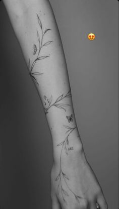 a woman's arm with flowers on it