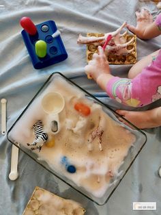 a child is playing with toys on the table