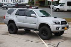 a silver toyota truck parked in a parking lot