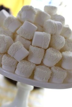 a white plate topped with marshmallows on top of a table