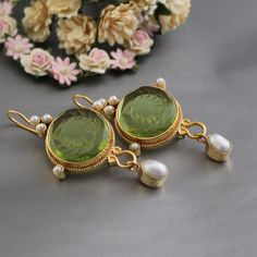 ✽ D E T A I L S   {Gemstone} - Green Glass   {Gemstone Size} - 18 mm    {Earring Height Including Hoop} - 5.5 cm   {Earring Width} - 2.8 cm   {Finish} - Smooth and high polished with brilliant shine.   {Note} -The earrings are made to order, production day is about 3-5 working days. The one you receive may be slight different from the one                  in the picture due to handmade nature, but it will be almost same as in the above picture.    These pieces are handcrafted from start to finis Elegant Green Round Bridal Earrings, Exquisite Green Drop Earrings, Elegant Green Earrings For Celebration, Elegant Green Gemstone Chandelier Earrings, Green Elegant Drop Earrings, Green Round Pearl Drop Earrings, Green Pearl Drop Round Earrings, Handmade Green Crystal Earrings For Wedding, Green Pearl Earrings For Anniversary