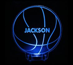 a lighted basketball with the name jackson on it is lit up in blue and black