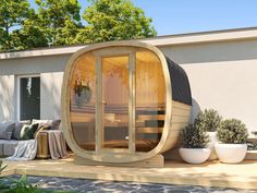 a hot tub sitting on top of a wooden deck next to a patio with potted plants