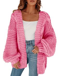 a woman wearing a pink cardigan sweater