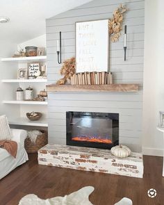 a living room filled with furniture and a fire place in the middle of the room