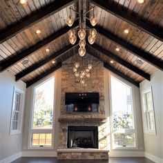 a living room filled with furniture and a fire place in the middle of an open floor plan