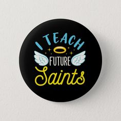 a black button with the words i teach future saints on it and an angel halo