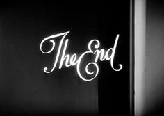 the end sign lit up in black and white