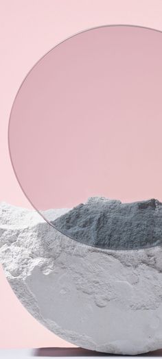 a large white object sitting on top of a table next to a pink wall and floor