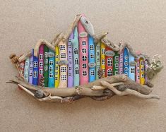 a colorful house made out of driftwood on the beach