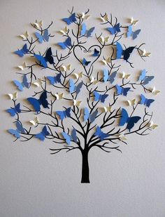 a blue and white tree with birds on it's branches is mounted to the wall