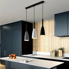 a modern kitchen with black cabinets and white counter tops is pictured in this image, there are three pendant lights hanging over the island