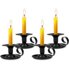 set of four black candle holders with yellow candles