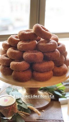 a stack of doughnuts sitting on top of a cake plate