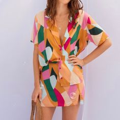 Stand out in style with this unique colorful button up blouse. Rayon Imported Multicolor V-neck Shirt For Summer, Multicolor V-neck Summer Shirt, Colorful V-neck Blouse For Vacation, Orange V-neck Summer Shirt, Orange V-neck Shirt For Summer, Vibrant V-neck Blouse For Day Out, Multicolor V-neck Color Block Blouse, Colorful Printed Casual Blouse, Multicolor V-neck Rayon Blouse