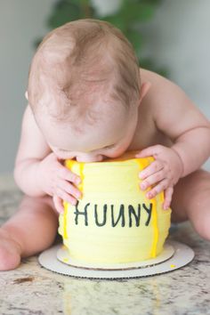 a baby sitting in front of a cake with the words funny on it