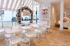 the inside of a restaurant with tables and chairs