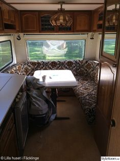 the inside of an rv with a table and couch