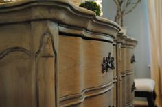 an antique dresser with drawers and knobs in a room