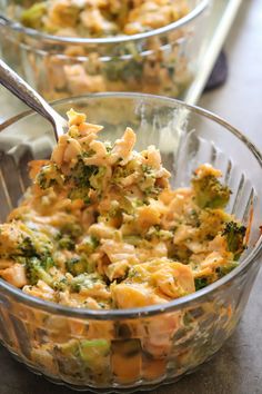 broccoli and cheese casserole is in a glass dish with a spoon