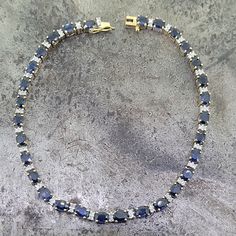 Beautiful two-tone 14k gold sapphire and diamond bracelet. The bracelet is 7 1/2" long. there are thirty 3x4mm oval sapphires with a total carat weight of 7.5cts and have A quality. There are sixty 1mm diamonds with I1 clarity and a total carat weight of 0.30cts. The bracelet weighs 9.33 grams. Oval Sapphire Tennis Bracelet With 17 Jewels, Oval Sapphire Diamond Bracelet, Sapphire Bracelet, Earings Piercings, Diamond Bracelet, Two Tone, Sapphire, Diamonds, Yellow Gold