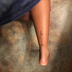 a woman's foot with the word faith written on it, in black ink